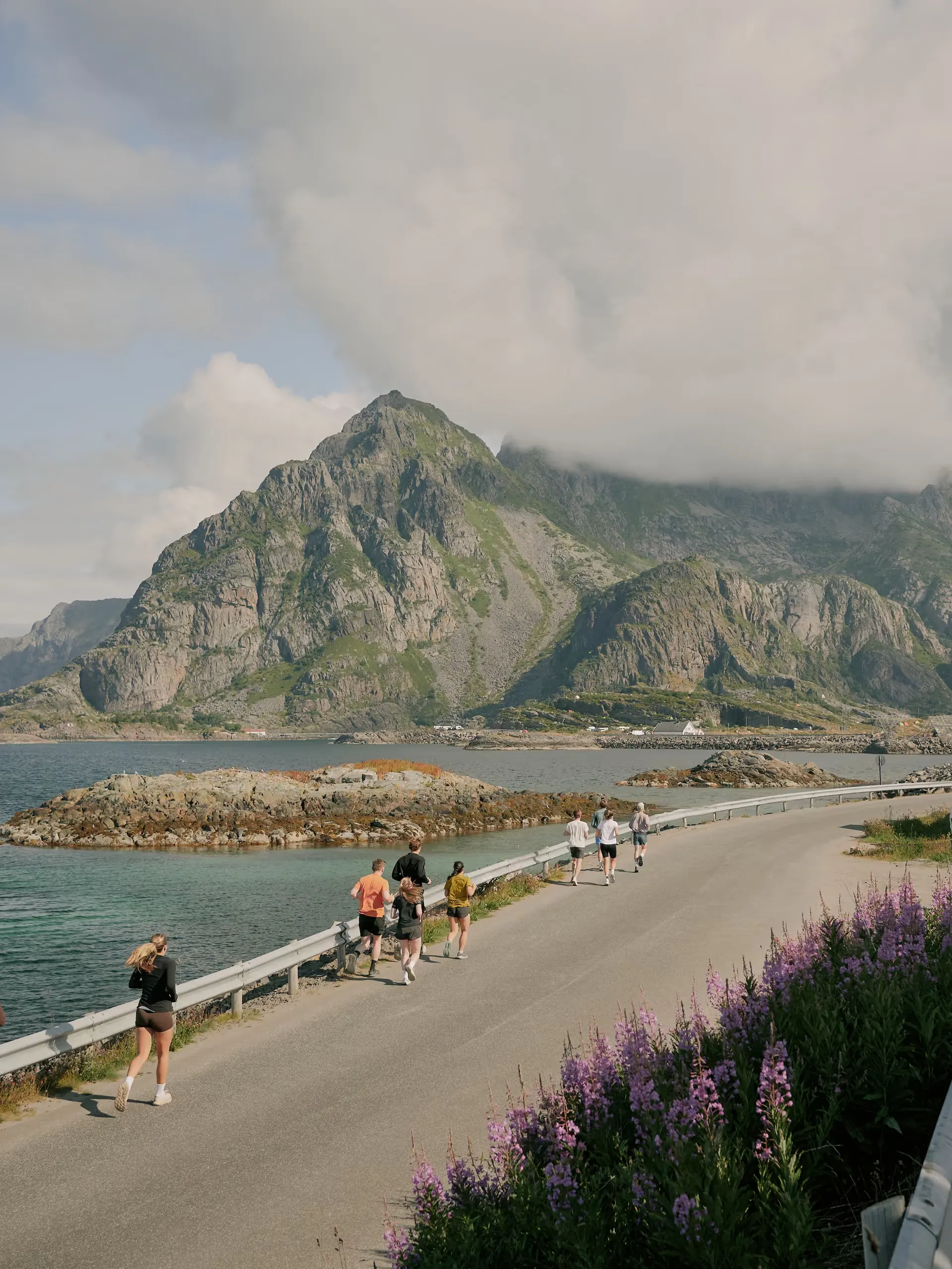 A fishing village under steep mountains on a summer day