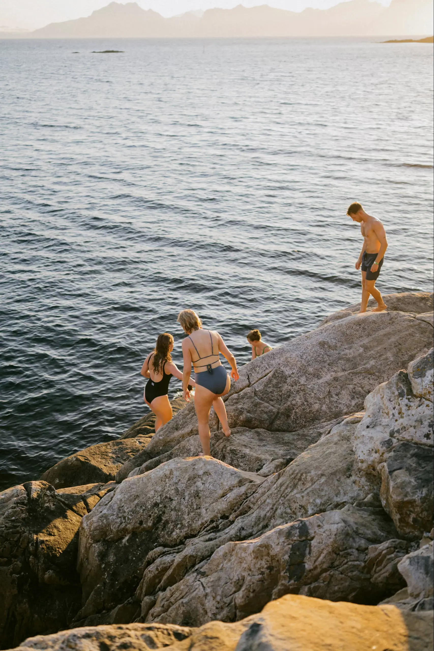 Guests climbing down the rocks for a swim in the sea